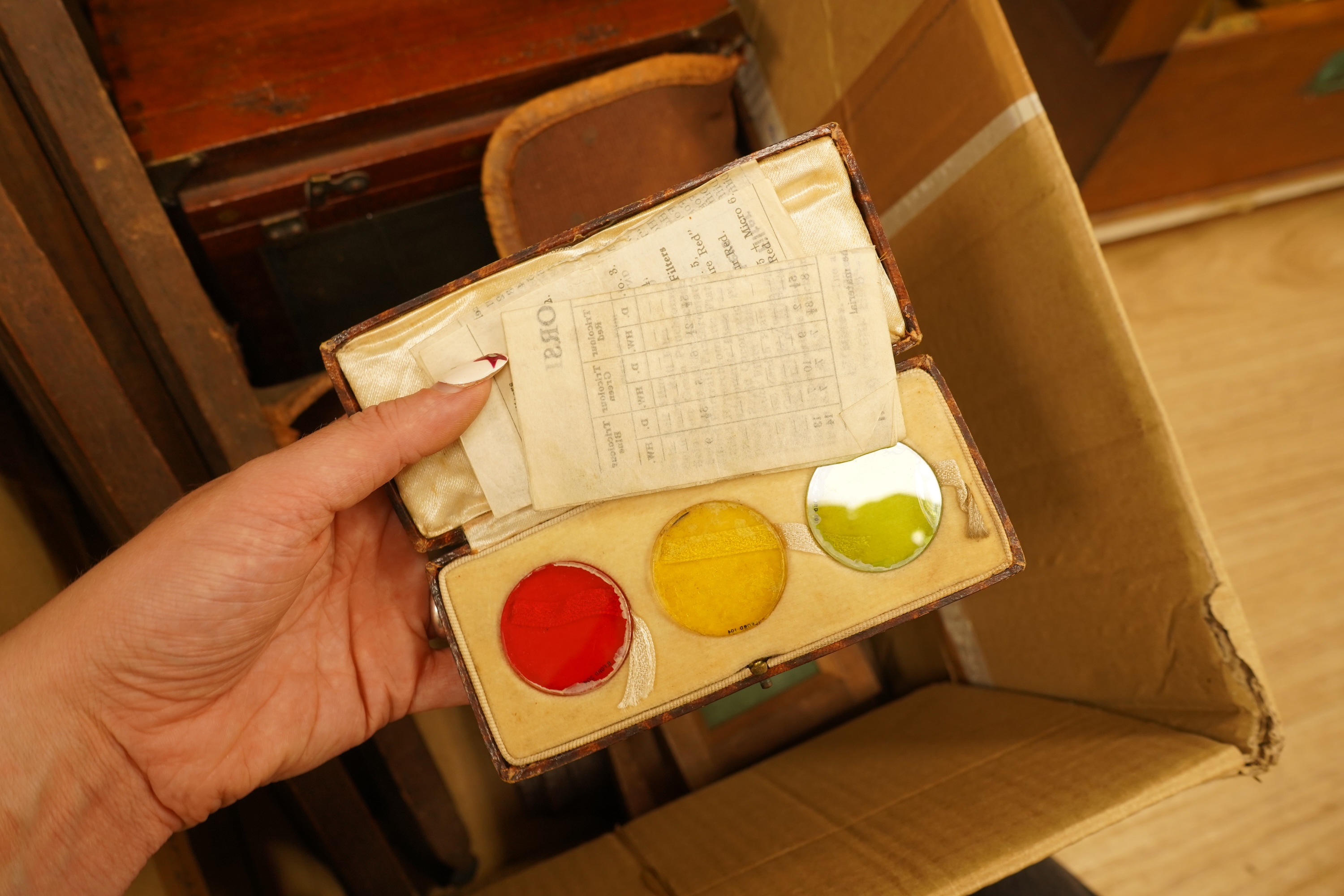 An early 20th century mahogany and brass half plate camera, filters and accessories